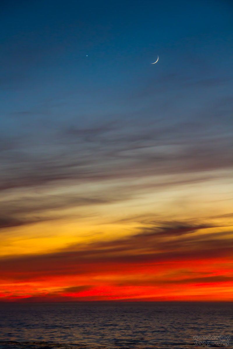 Venus and Moon above the sunset at Point Lobos -- blue, cloud, moon, ocean, orange, purple, red, sunset, venus, water, yellow