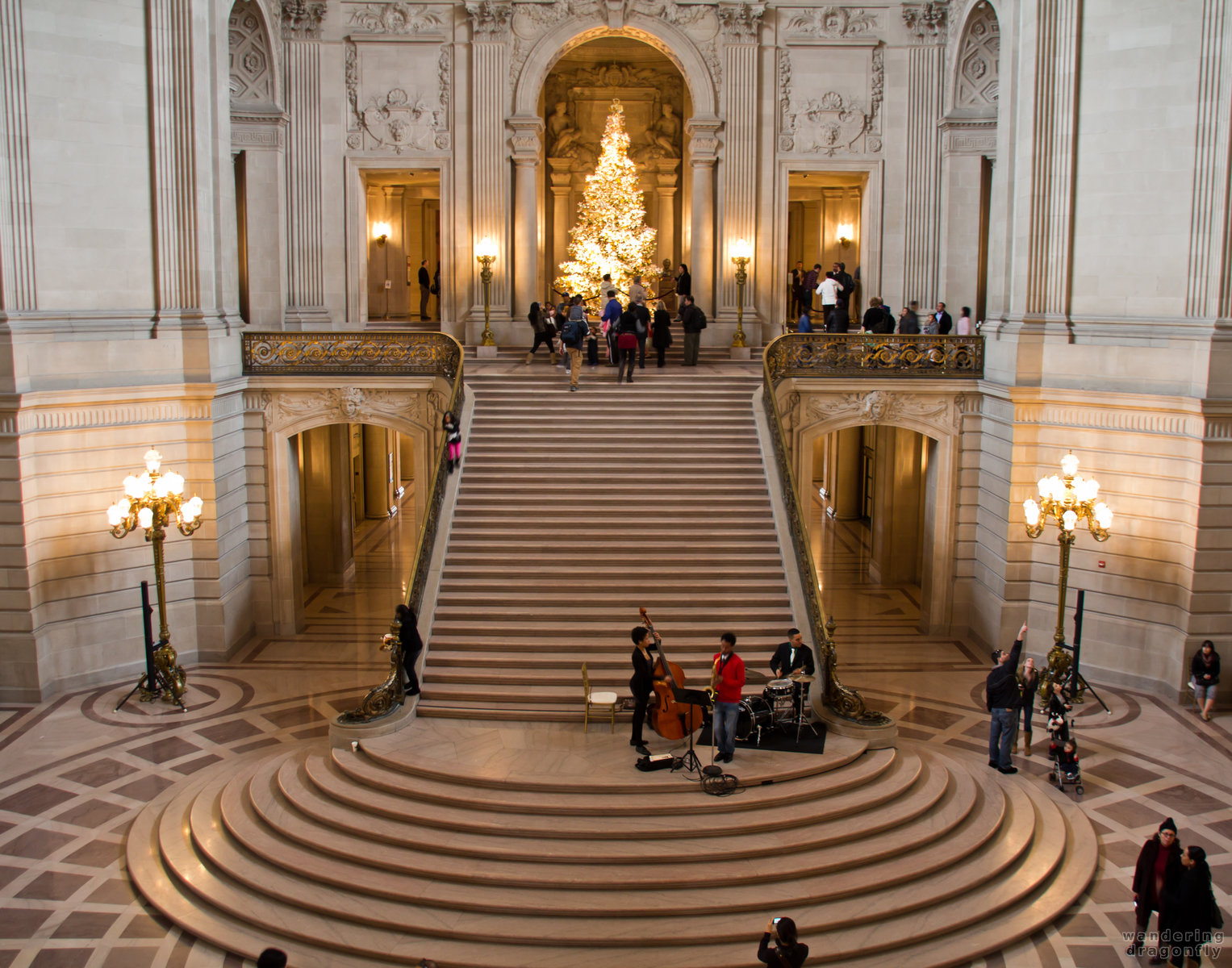 Rotunda of San Francisco City Hall -- christmas tree, lamp, people, playing music, stairs